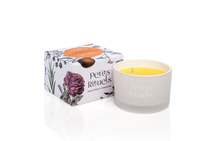 Orange scented travel candle in white frosted glass and floral packaging.