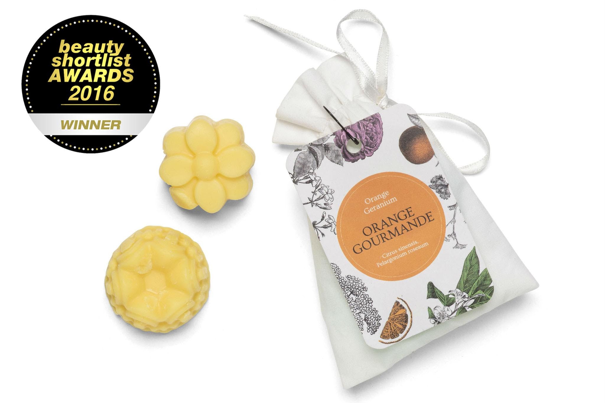 Orange Scented Wax Melts in multiples of 2  in a white cotton bag.
