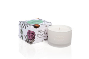 Mint candles in white frosted glass and floral packaging.