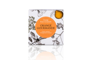 Floral packaging of orange scented candle.